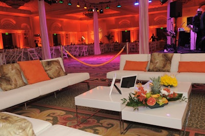 Event Management Group provided white furniture accented with orange and palm tree-printed pillows to create the V.I.P. area in the main ballroom.