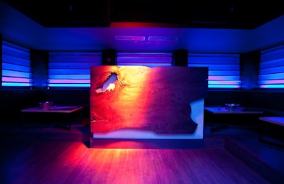 At Recess, the DJ booth is fronted by a massive walnut slab.