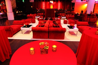 Red lounge furniture sat atop a white carpet in the main room.