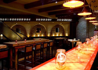 The alabaster pizza and enoteca bar provides a focal point on the lower level, which holds 110.