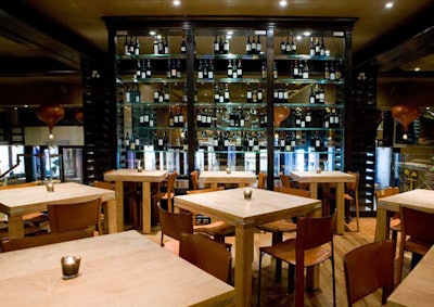 A floor-to-ceiling glass bar on the main level is equipped with an Enomatic wine serving system.
