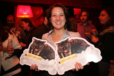 Guests posed with cutouts of the Web site's mascot, Groupon the cat.