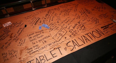 A so-called 'tablet of salvation' let guests write secrets on a paper-topped table. Organizers awarded $100 worth of Groupon credit to the author of the most intriguing confession.