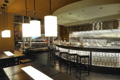 The open kitchen has its own semicircle of seating.