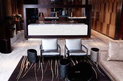 In the hotel's street-level lobby is a lounge with bamboo-paneled walls, low-slung couches, and marble tabletops.