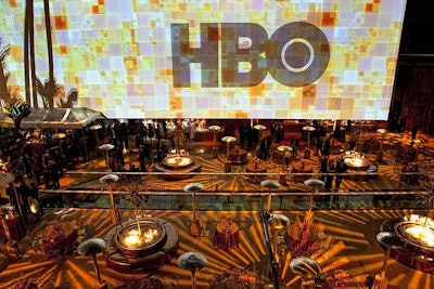 Golden starburst-style lighting and rotating logo projections marked HBO's Golden Globes party.