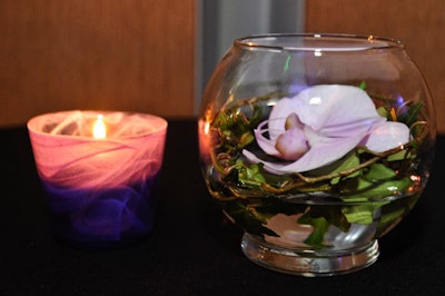 Cocktail tables featured votives and floating blooms by Winston Flowers.