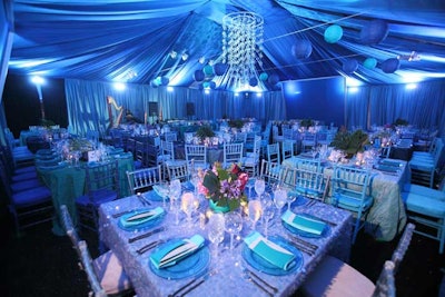 The honoree dinner was held in a fabric-draped tent set up outside Meridian House and was decorated in shades of blue, with paper lanterns and clear plastic spheres dangling from the ceiling.