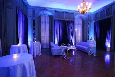 The honoree dinner's 190 guests gathered for cocktails prior to dinner in rooms splashed with blue uplighting and furniture grouped for conversation.