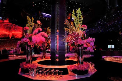 Towering floral arrangements included orchids and feathers.