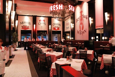 The restaurant's main dining room is primarily decorated in black and white with red accents.