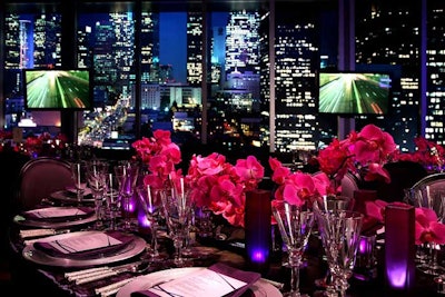 Fuchsia floral arrangements topped dining tables.