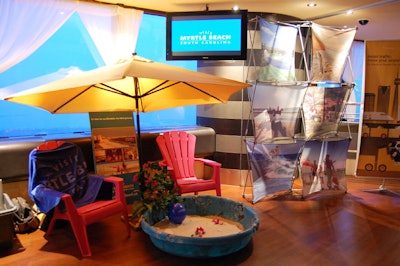 Beach umbrellas, lounge chairs, and a sandbox added to the beach-themed decor at the CN Tower.