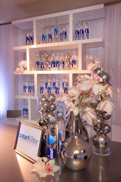 Caravents' design for In Style's lounge included a clean-looking bar decked with orchids and silver balls in clear vessels to show off SmartWater.
