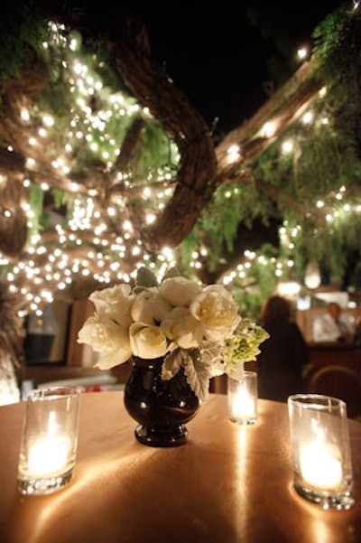 For Lionsgate, gold cloths from Wildflower Linen and white flower arrangements of ranunculus and roses from Collage Floral Design topped tables for an old Hollywood look.