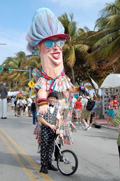 Stilt walkers from Fantasy Theater Factory entertained the crowd at the street fair on Saturday morning before walking in the classic car parade.