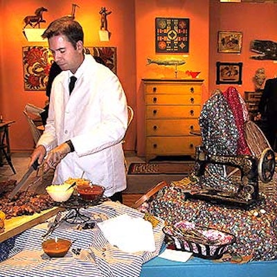 Colorful bolts of fabric and buttons accompanied an antique sewing machine set up at the carving station.