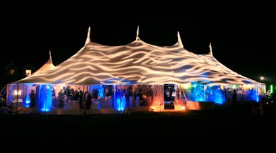 For a private event in August, Levy Lighting NYC projected a wave pattern onto the outside of a tent made out of sailcloth. To reduce clutter, the equipment was positioned outdoors while the pattern appeared on the inside.