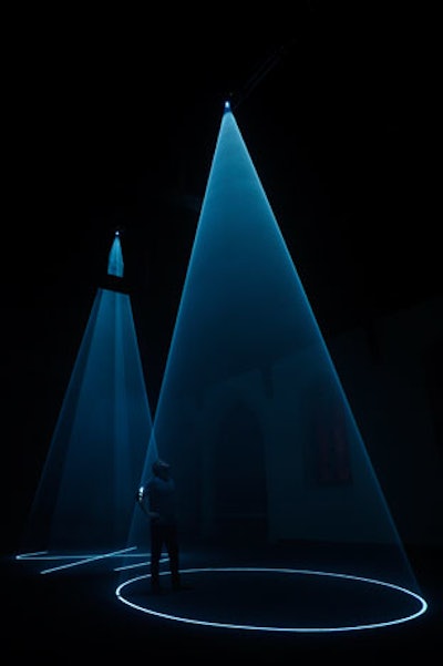 In June, artist Anthony McCall brought his 3-D light sculpture 'Between You and I' to Governors Island as part of Creative Time's public art quadrennial. In the island's St. Cornelius Chapel, two ghostly light projections interacted with each other, the visitors, and the architecture of the dark church.