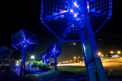 Open since July, 'Sunflowers, an Electric Garden' is a solar art installation in Austin, Texas, created by Harries/Héder Collaborative, a Cambridge, Massachusetts-based firm specializing in public art. The flowers have photovoltaic solar collector panels that generate solar energy during the day and cast a blue glow over a pedestrian walkway at night.