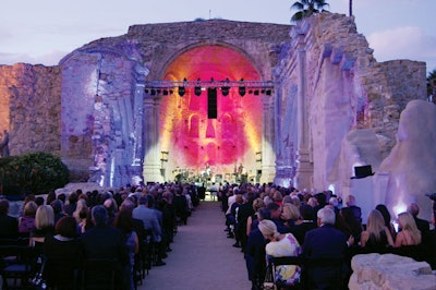 The Mission San Juan Capistrano's September benefit gala included a concert by Roni Benise in the historic stone church. In order to preserve the site, Shine Lighting installed a self-climbing truss that prevented equipment from touching the building. During the performance, moving and LED lights highlighted the architecture of the church with colors and patterns.