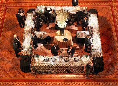 Eight bartenders poured drinks at the reception's square bar, which featured an eight-foot-tall arrangement of white hydrangea, roses, amaryllis, and gold birch branches from Randy Watts Design.