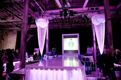 5th Element Events set up a custom runway between the two main bars and created a framed screen, which provided a shadow effect for dancers during the burlesque performance.