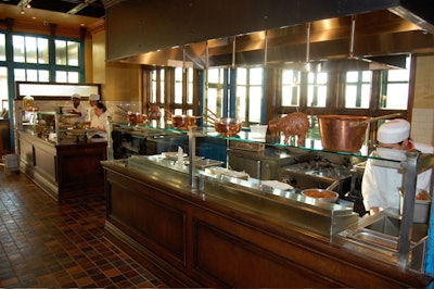 An open pass-through kitchen separates the bar from the dining rooms.
