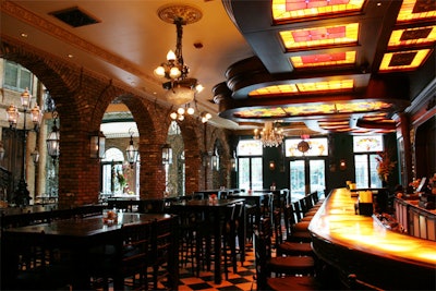 Wrought iron lanterns and crystal chandeliers illuminate the bar area on the main floor.