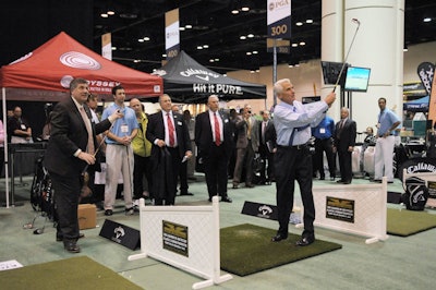 P.G.A. of America honorary president Brian Whitcomb gave Florida Governor Charlie Crist a golf lesson at the trade show.