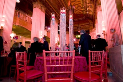 Kehoe topped the tables with silver candelabra strung with crystal garland. Crowning the centerpieces, hurricanes held mock pillar candles surrounded with roses.