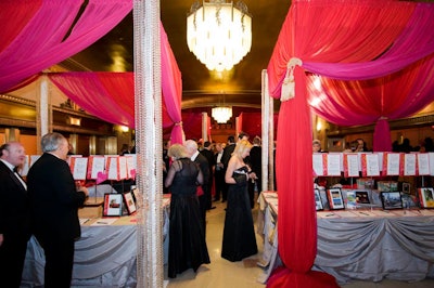 Red chiffon drapes tied with gold tassels topped the silent auction tables.