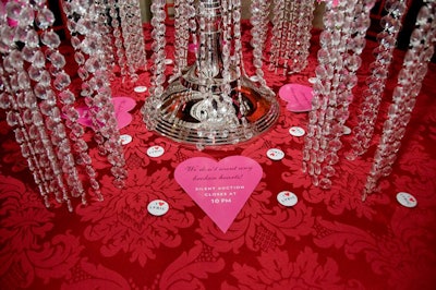 Magnetic pins reading 'I Love Lyric' dotted tabletops, where heart-shaped signage reminded guests that the silent auction closed at 10 p.m.