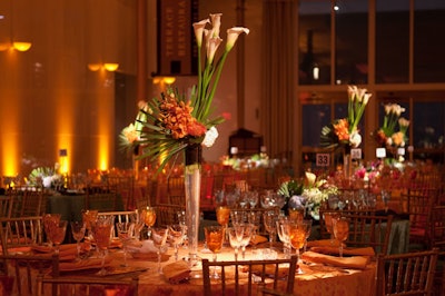 Hydrangea, calla lily, and orchid floral arrangements by Volanni topped the tables, in low vases and tall fluted ones.