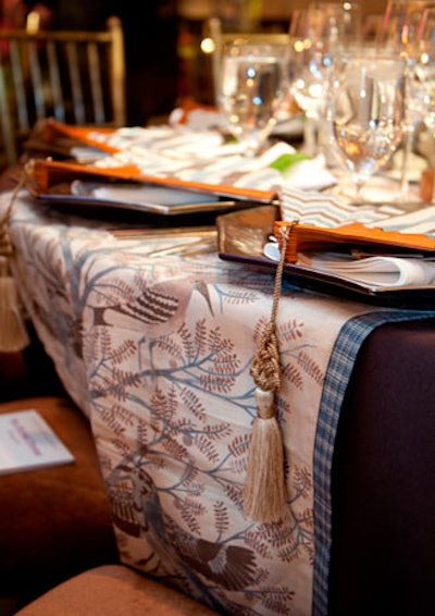 Katie Leede and Prudence Designs used a table runner printed with birds and placed paper fans atop each plate.
