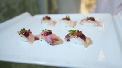 Waiters served yellowtail hamachi appetizers during the reception.