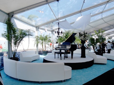 In one lounge area, white leather sofas surrounded a piano.