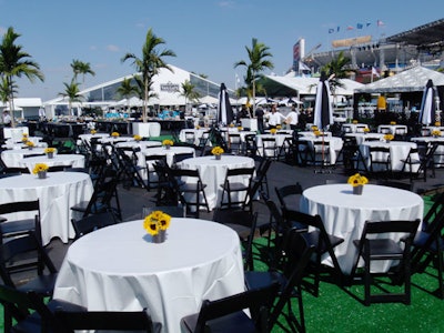 Sunflower centerpieces added a shot of color to the black and white tables outside the Tailgate tents.