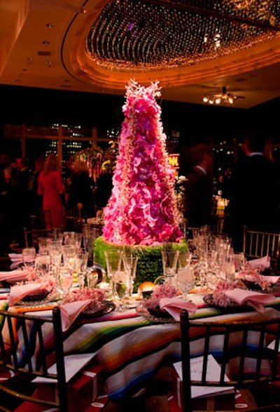 Timothy Whealon's table for Baccarat was festive, with a colorful striped linen and a tall orchid sculpture set on a cube of grass.