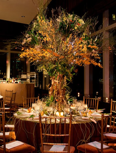 Michael Walter's design for Lexington Gardens got an earthy look from a moss-covered orchid tree that appeared to extend its roots over the edge of the table.