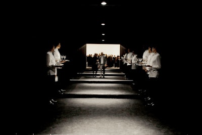 Guests passed through a tunnel, flanked on either side by servers bearing trays of champagne.