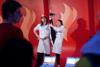 A sponsor of the Olympic torch relay, Coke is using the symbol as a backdrop for branded souvenir photos.