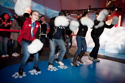 One of the games in the pavilion requires guests to don giant polar bear paw gloves.