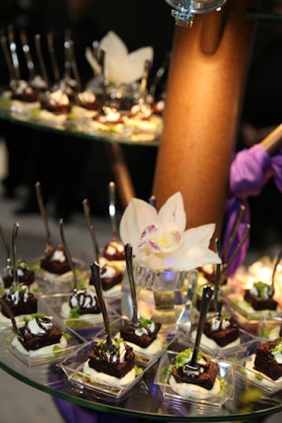 Another dessert sponsor, Catered by Design, presented a chocolate dish on glass tables topped with white orchids.