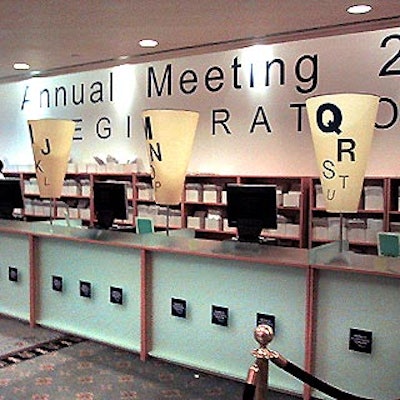 The conference's registration area features large cones labeled with different letters of the alphabet to show the event's high-powered attendees where to sign in.