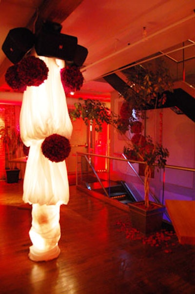 Organizers scattered rose petals on the floor and wrapped pillars in sheer white fabric.