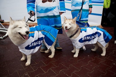 A trio of huskies, wearing Samsung slickers, are on hand to pose for photos outside the pavilion with one the Vancouver Games' official mascots, Quatchi the Sasquatch.