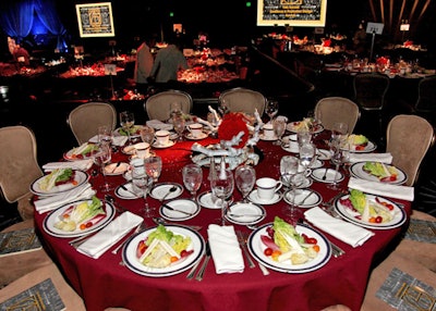 Flowers from Sandy Rose topped red-clothed tables.