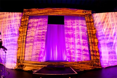 Models walked through a 12- by 9-foot gilded picture frame at the far end of the room onto the runway for the fashion show.