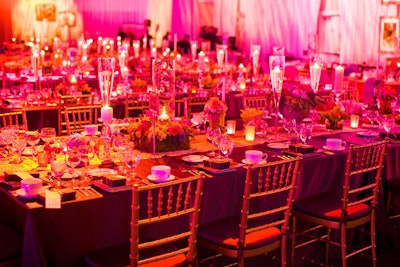 ConceptBAIT placed long dinner tables in the main ballroom and adorned them with multiple centerpieces and candles atop a runner.